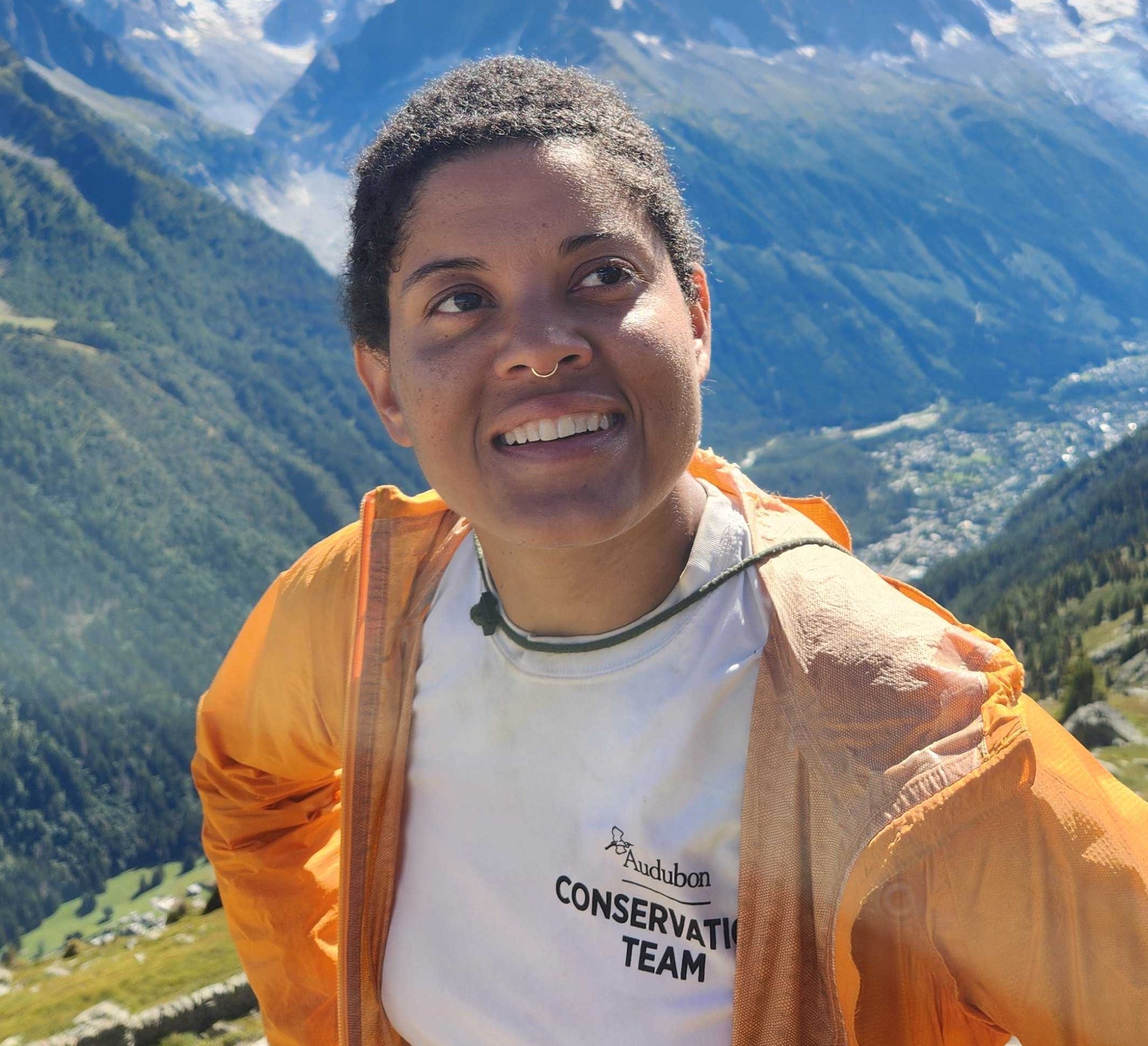A photo of Debbie Archer hiking in the mountains.